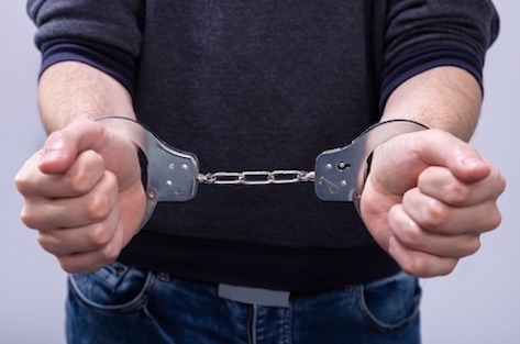 man in handcuffs child molestation defense